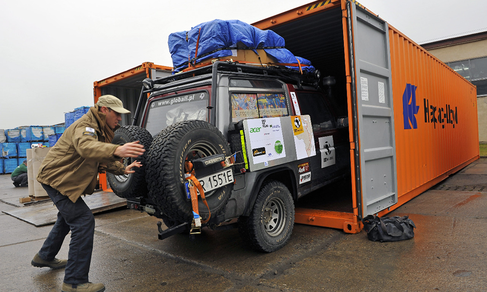 Man unloading vehicle from a container at the port during the customs clearance process.