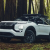 2026 Mitsubishi Outlander SUV parked on a forest trail, showcasing its rugged design and adventure-ready capability.