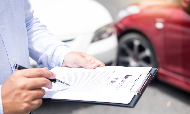 Buyer reviewing vehicle insurance documents before VIN verification for car export from Dubai.