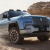 Luxury SUV driving through the desert landscape in GCC countries showing why SUVs are popular in UAE, Dubai, and Gulf markets